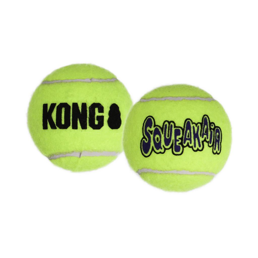 Two green KONG SqueakAir tennis balls on a white background