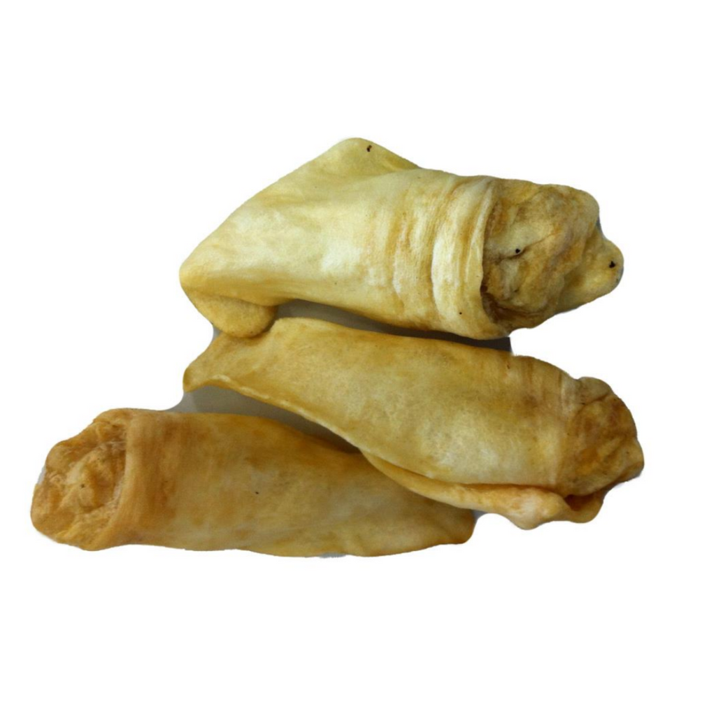 A stack of air-dried lamb ears, with a golden-brown color and a natural, curved shape.