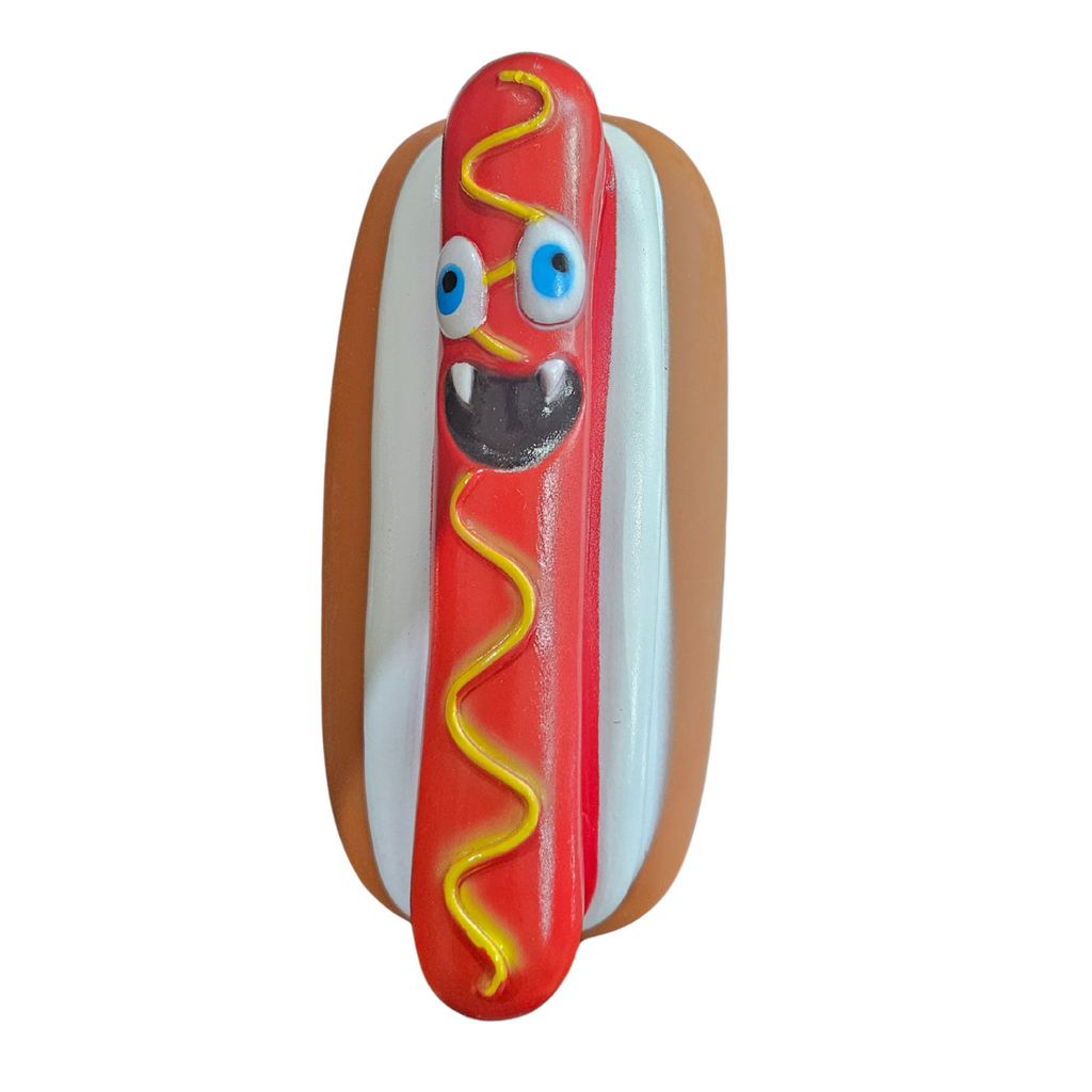 Toy hot dog with a angry face on a hot dog with bun